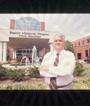 John Leslie in front of Baptist Memorial Hospital North Mississippi, image 001 by Author Unknown